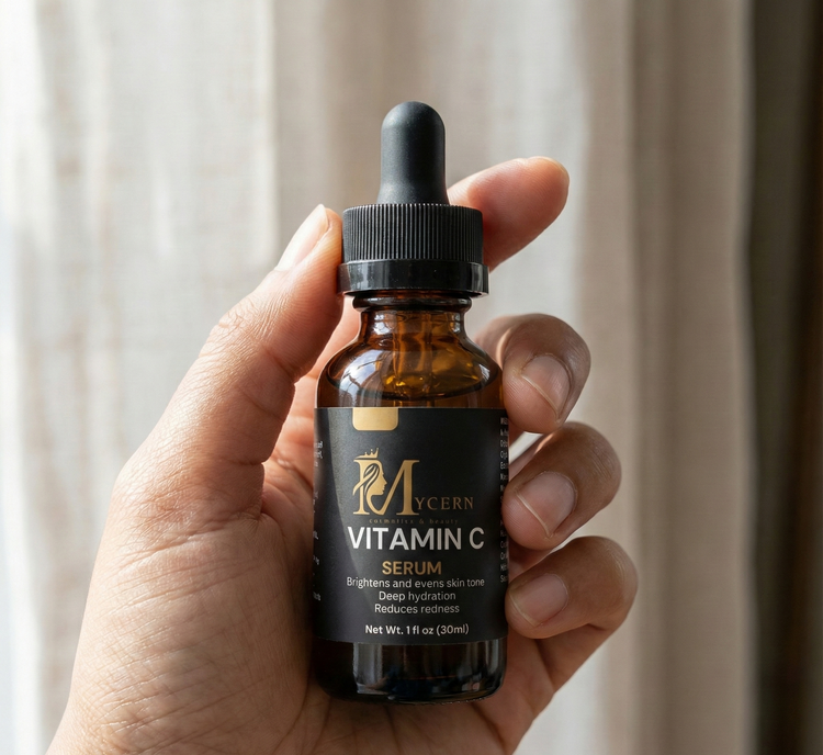 Hand holding a bottle of Mycern Vitamin C Serum against a neutral background